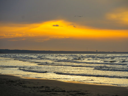 A colorful sunset on the shore of the Gulf of Riga in Latvia.の写真素材
