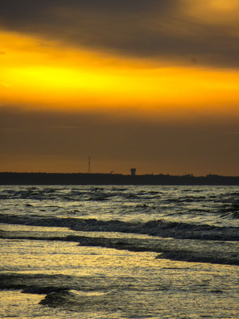 A colorful sunset on the shore of the Gulf of Riga in Latvia.の写真素材
