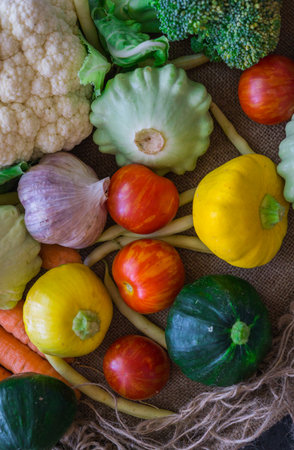 Different vegetables, small patissons, along with other vegetables, cauliflower, broccoli, garlic, cucumbers grown on an eco-farmの写真素材