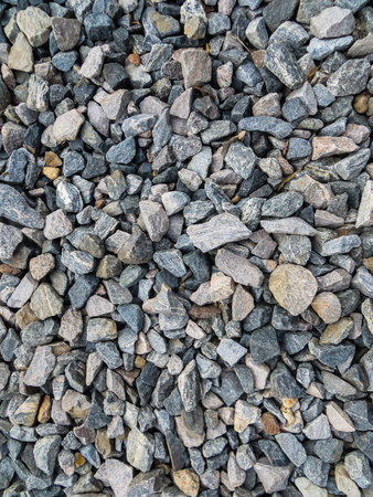 Background of colored granite pebbles scattered on the groundの写真素材
