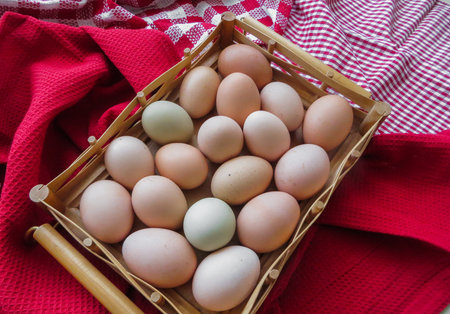 Organic eggs.Fresh country chicken eggs, lying in a wooden basket, on a table.