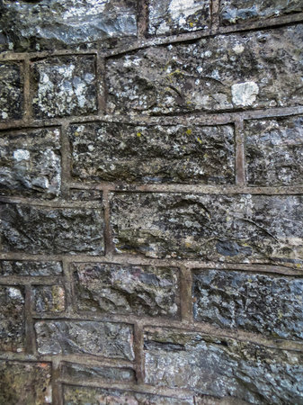 Decorative lined wall of gray, treated stones