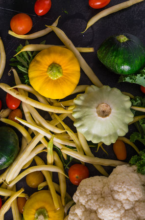 Multi-colored squash, cauliflower, cherry tomatoes and green beansの写真素材