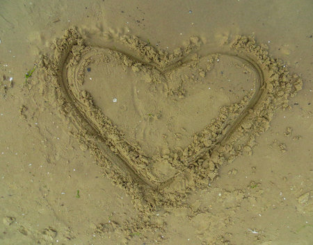 Artistic Sand drawings on the beach with pebbles and wooden sticksの写真素材