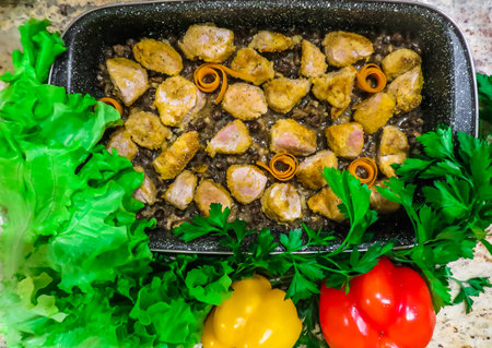 pieces of veal, baked in the oven with peasの写真素材