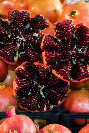 Peeled red pomegranate fruits and berries in the marketの写真素材