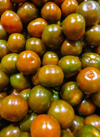 Fresh dark tomatoes, put up for sale in a supermarketの写真素材