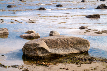Large stone boulders on the shore of the Gulf of Riga on a summer dayの写真素材