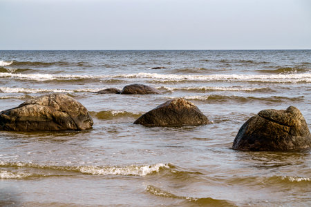 Large stone boulders on the shore of the Gulf of Riga on a summer dayの写真素材