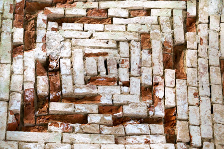 Old masonry wall of red bricks in the shape of a square.の写真素材