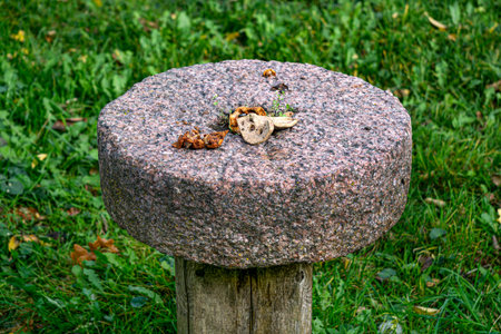 A granite circle from an old mill used as a side table.の写真素材