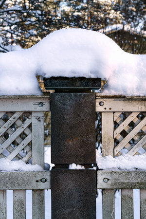 The fence posts are covered with white snow