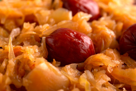 Traditional Homemade Stewed cabbage with sausages on white plateの写真素材