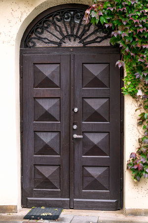 Beautiful old wooden door with iron ornaments in the old town