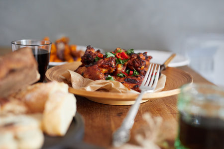 Low angle view of table served with traditional British Sunday roast dinner, featuring roasted chicken, squash and sweet potatoesの写真素材
