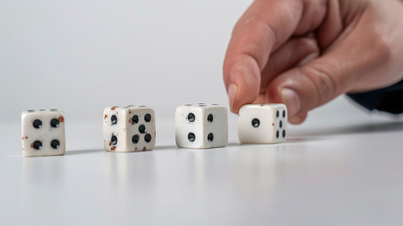 Close up shot of a person playing with dice on a white backgroundの素材