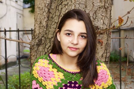 Beautiful teen girl portrait in a crochet ponchoの写真素材
