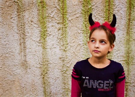 Sweet little girl dressed like a devil