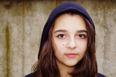 Beautiful teen girl with a hoodの写真素材