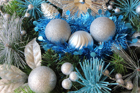 Silvery Christmas balls and blue tinsel on a Christmas wreathの写真素材
