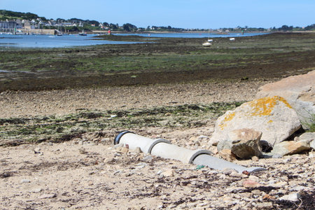 Pipe come out onto a beachの写真素材