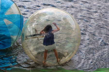 Girl in an aqua bubble on a riverの写真素材