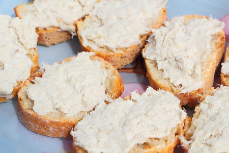 Slice of French baguette with mackerel rillettes on a plateの写真素材