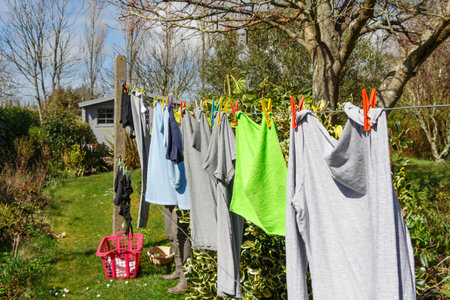 Washing line with t-shirts and towel drying in a garden