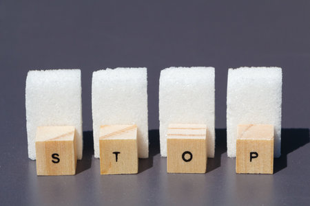 Stop written in wood letter and sugar cubes