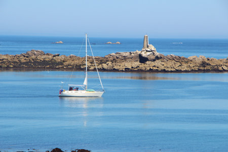 Coast and sailboat in Landunvez at low tideの写真素材