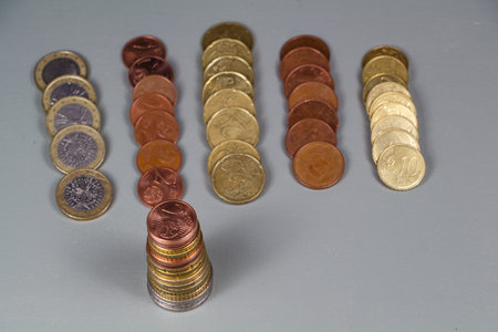 Heaps of euro coins and cents with some heaps spreadの写真素材