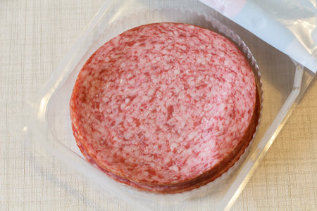 Slices of salami in an open plastic packaging