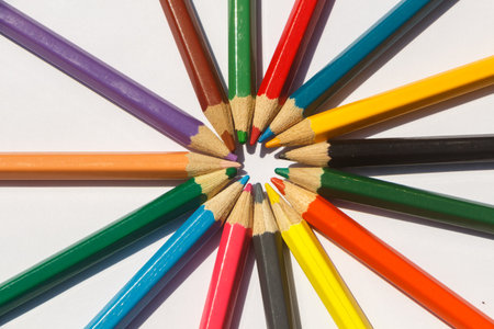 Colored wooden pencils on white background