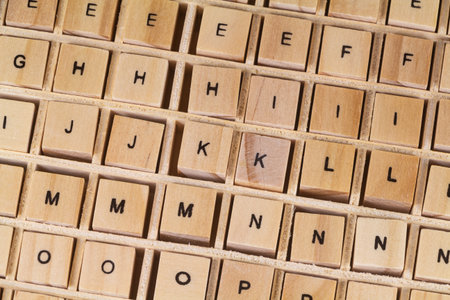 Alphabet letters written on wooden cubes in a boxの写真素材