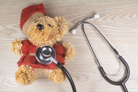 Teddy bear and black stethoscope as concept for pediatric healthcareの写真素材