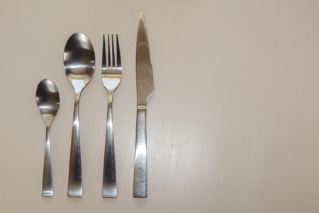 Fork, knife, teaspoon and spoon on a table