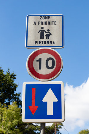 Road sign pedestrian priority written in french language, 10 kilometers per hour and priority directionの写真素材