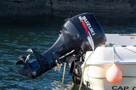 Primelin â€“ France, October 04, 2018 : Suzuki motor of a boat in Primelin harbor