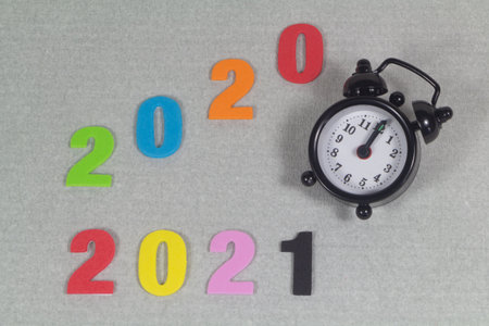 2020, 2021 in colored figures and black alarm clock