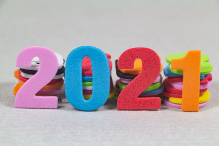 2021 in colored figures against heaps of colored figuresの写真素材