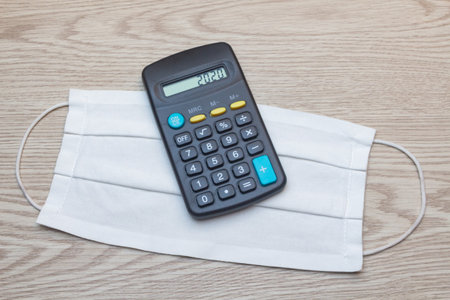 Fabric mask and calculator with 2020 on the screenの写真素材