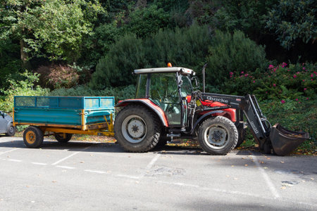 Guipavas â France, September 13, 2018 : tractor Massey Ferguson with trailer parked in the backyard of a farmのeditorial素材