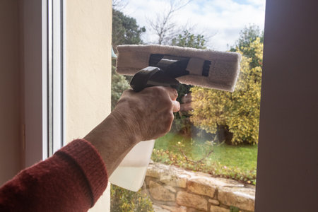 To wash the window of a door with a scraper