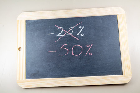 Percentage written on a chalkboard slate for reduction in a shopの写真素材