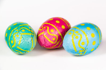 Chocolate eggs wrapped in colored papers for Easterの写真素材