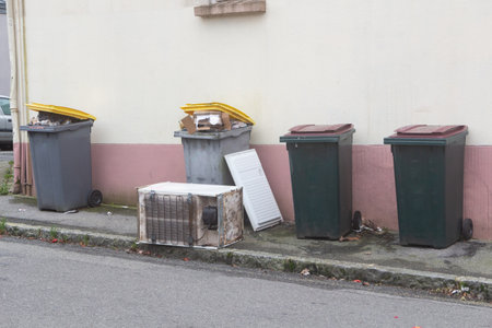 Garbage bin and left-behind fridge in a street in Brestの写真素材