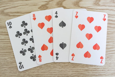 Hearts, clubs and spades playing cards spread on a table