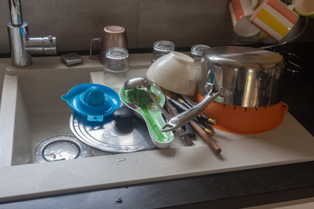 Dishware drying by the sink after cleaningの写真素材