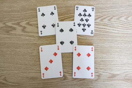 Five playing cards on wooden background