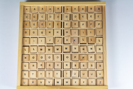 Alphabet letters written on wooden cubes in a boxの写真素材